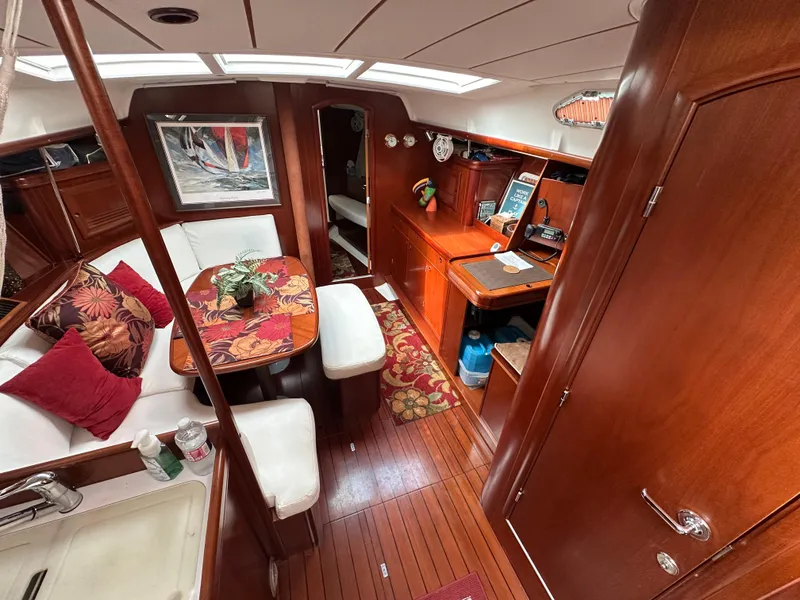 Slide: The Image of Interior of a 2004 Beneteau 393 yacht with elegant wood finish and cozy seating area. - 33
