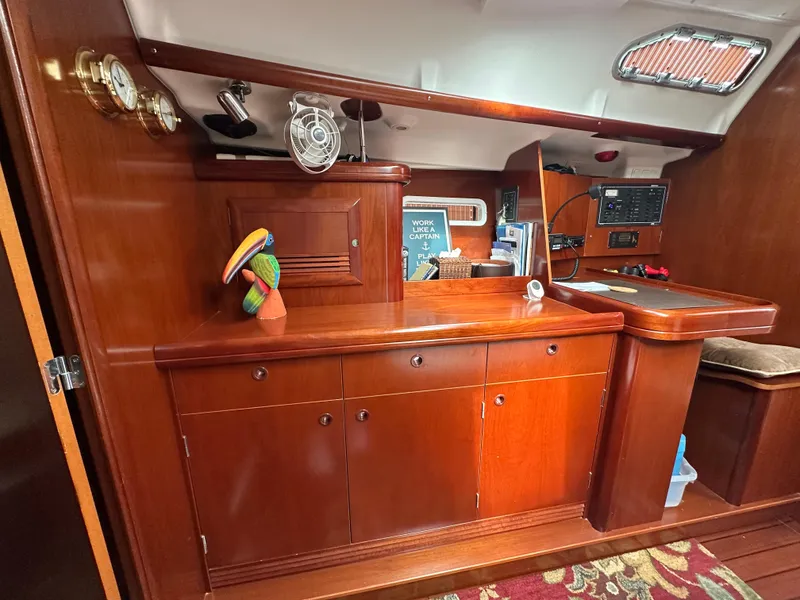 Slide: The Image of Interior of 2004 Beneteau 393 sailboat with wooden cabinetry and nautical decor. - 40