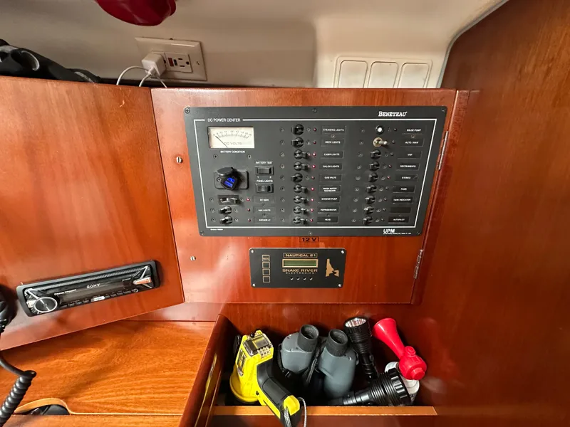 Slide: The Image of Electrical panel of a 2004 Beneteau 393 sailboat with various controls and equipment. - 43