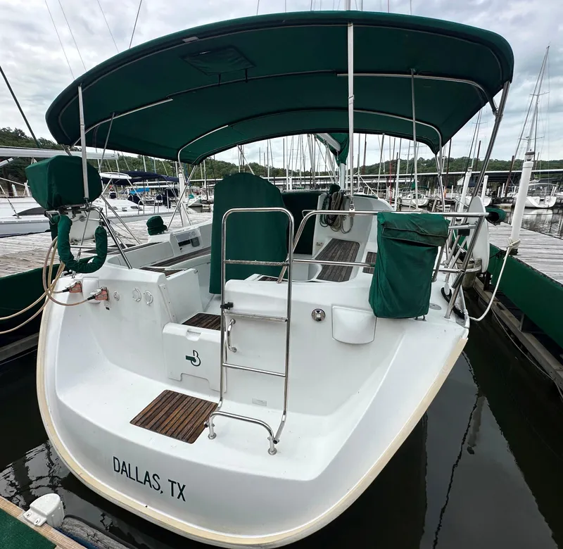 Slide: The Image of 2004 Beneteau 393 sailboat docked, featuring green canopy and wood accents, Dallas, TX. - 8