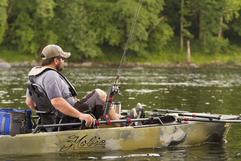 Slide: The Image of Man fishing on a 2025 Hobie Pro Angler 12 360 kayak in a serene lake. - 4