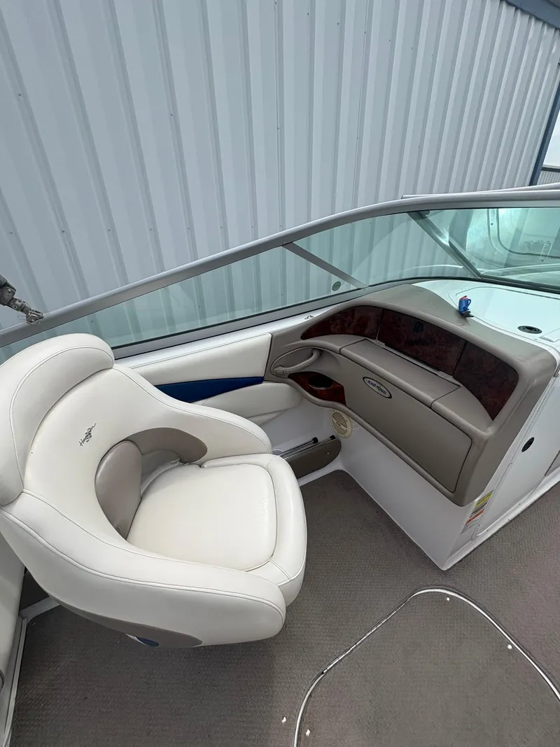 Slide: The Image of 2002 Four Winns 260 Horizon boat interior with white seating and dashboard. - 12