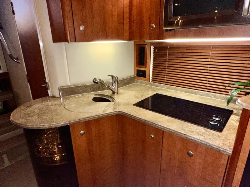 Slide: The Image of Luxurious 2009 Cruisers Yachts 360 Express kitchen with sleek countertops and modern appliances. - 47