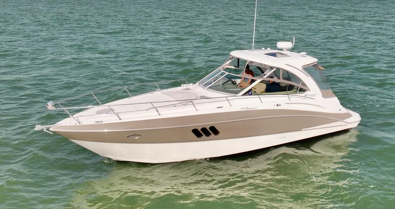 Slide: The Image of 2009 Cruisers Yachts 360 Express on calm water, showcasing sleek design and luxury features. - 16