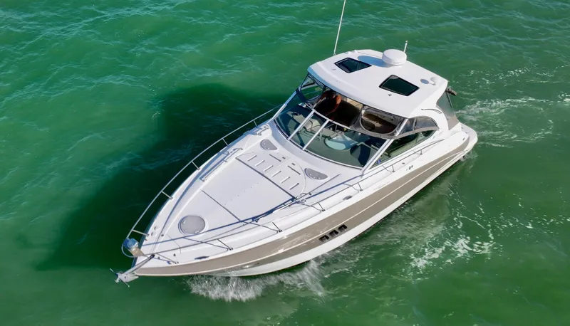 Slide: The Image of 2009 Cruisers Yachts 360 Express navigating on clear green water. - 2