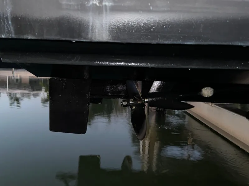 Slide: The Image of 2009 Cruisers Yachts 360 Express propeller and rudder detail near water surface. - 21