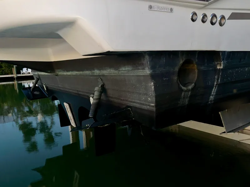 Slide: The Image of 2009 Cruisers Yachts 360 Express hull detail, docked in calm water. - 22