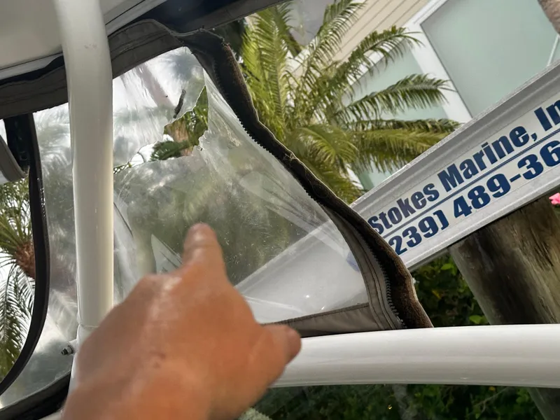 Slide: The Image of Hand pointing at damaged window on 2009 Cruisers Yachts 360 Express. - 27
