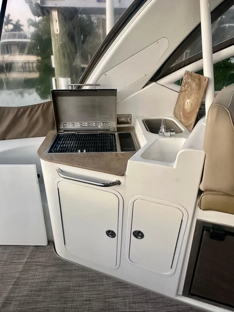 Slide: The Image of 2009 Cruisers Yachts 360 Express interior with grill and sink setup. - 28
