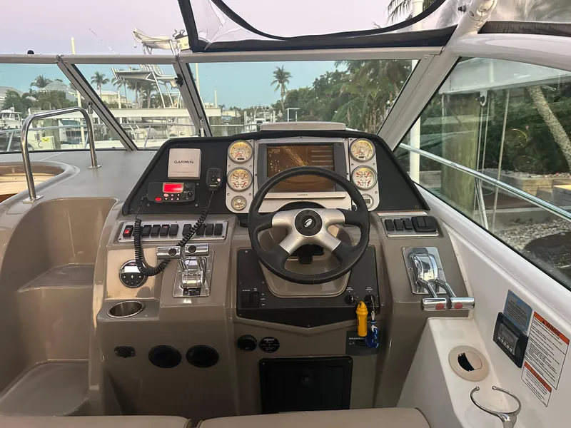 Slide: The Image of Helm of 2009 Cruisers Yachts 360 Express with steering wheel and navigation controls. - 30