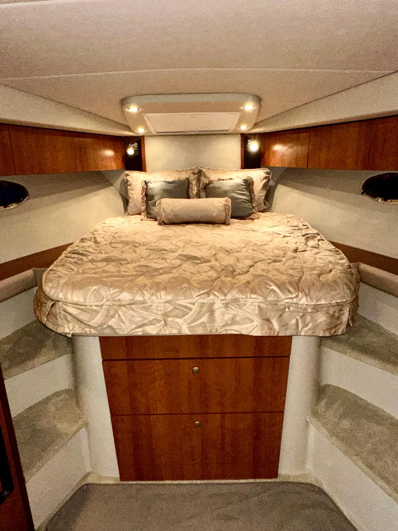 Slide: The Image of Luxurious 2009 Cruisers Yachts 360 Express cabin with elegant bedding and warm wood accents. - 40