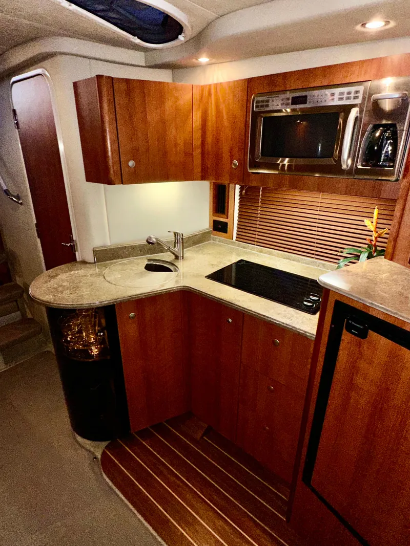 Slide: The Image of 2009 Cruisers Yachts 360 Express kitchen with wood cabinetry and modern appliances. - 45