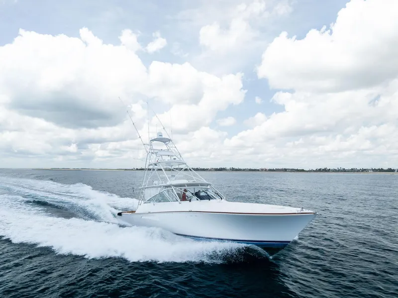 The Image of 2010 Viking 52 Open yacht cruising on open water under a cloudy sky. - 1
