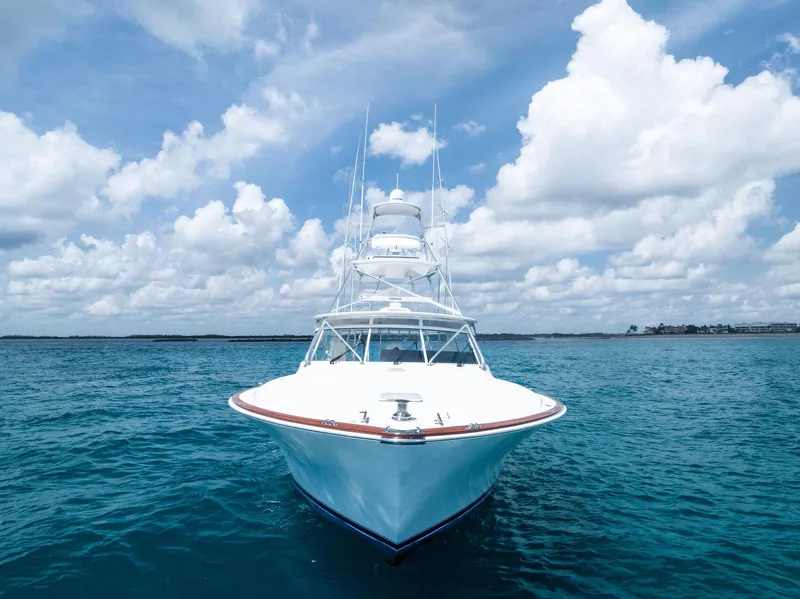 Slide: The Image of 2010 Viking 52 Open yacht on clear blue ocean under cloudy sky. - 11