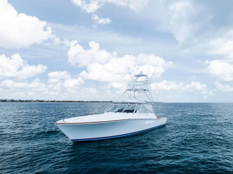 Slide: The Image of 2010 Viking 52 Open yacht on calm ocean under cloudy sky. - 16