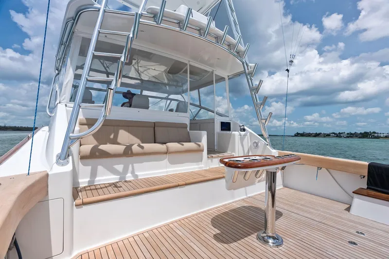 Slide: The Image of 2010 Viking 52 Open yacht with spacious deck and seating under a clear blue sky. - 19