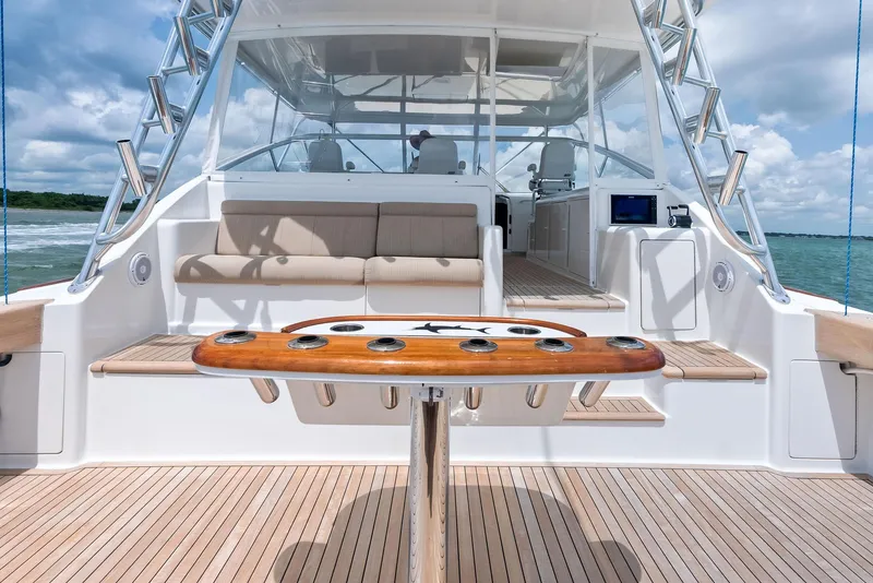 Slide: The Image of 2010 Viking 52 Open yacht deck with seating and fishing rod holders. - 20