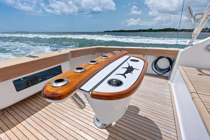 Slide: The Image of 2010 Viking 52 Open yacht deck with fishing rod holders, ocean view. - 22