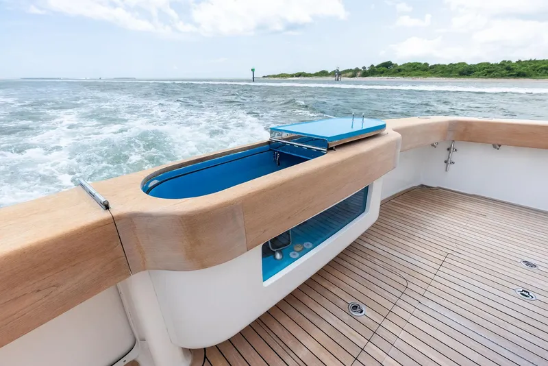 Slide: The Image of 2010 Viking 52 Open yacht deck with ocean view and teak flooring. - 23