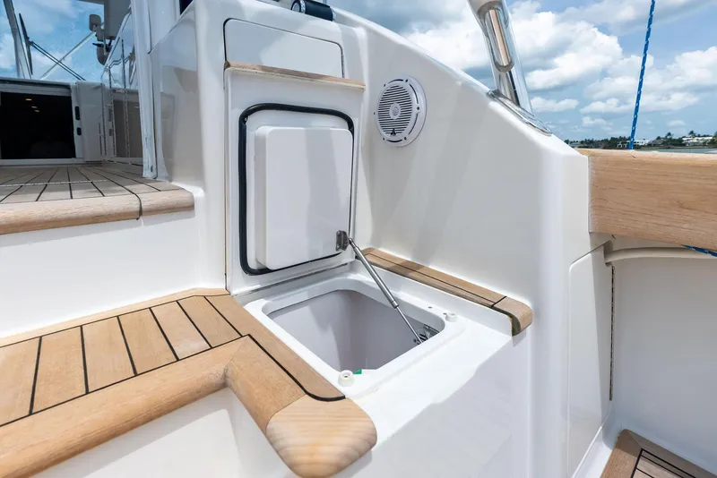Slide: The Image of 2010 Viking 52 Open yacht deck with built-in storage compartment and wooden accents. - 25