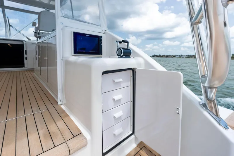 Slide: The Image of 2010 Viking 52 Open yacht deck with storage drawers and navigation equipment. - 26