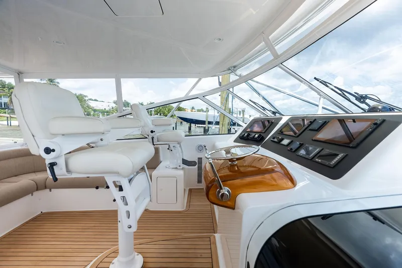 Slide: The Image of 2010 Viking 52 Open yacht helm with modern controls and luxurious seating. - 27