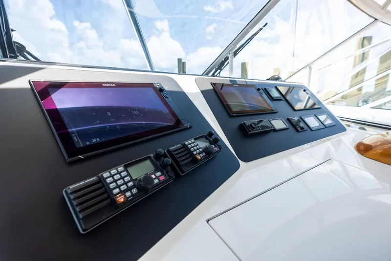 Slide: The Image of Control panel of 2010 Viking 52 Open yacht with navigation screens and communication devices. - 29