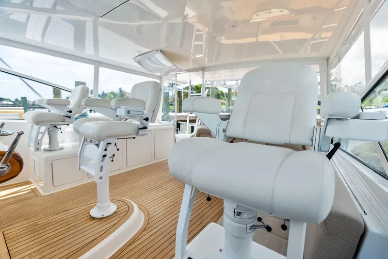 Slide: The Image of Luxurious interior of 2010 Viking 52 Open yacht with white seating and wooden flooring. - 30