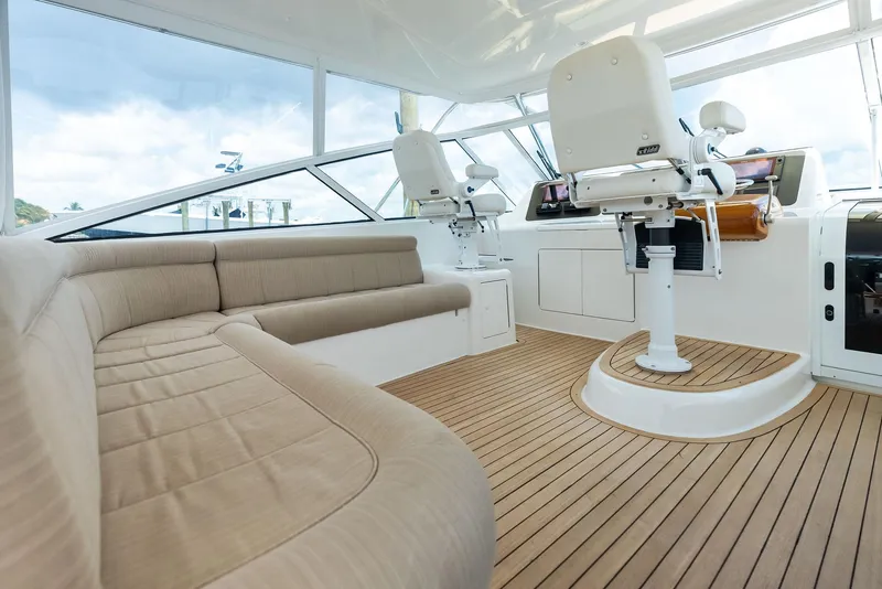 Slide: The Image of 2010 Viking 52 Open yacht interior with beige seating and wooden flooring. - 31