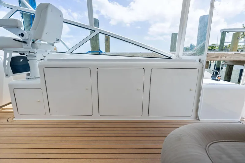 Slide: The Image of 2010 Viking 52 Open yacht interior with white cabinetry and wooden flooring. - 34