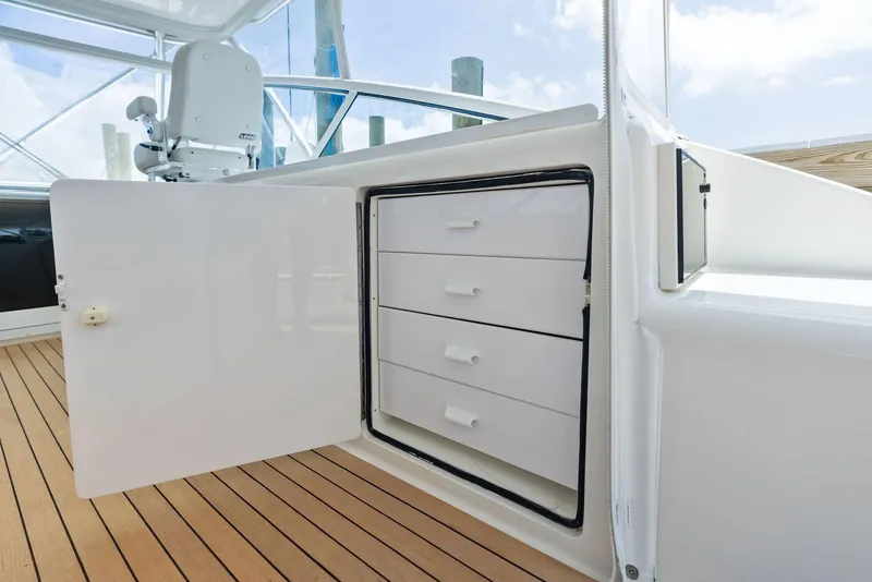 Slide: The Image of 2010 Viking 52 Open yacht with open storage cabinet and wooden deck. - 35
