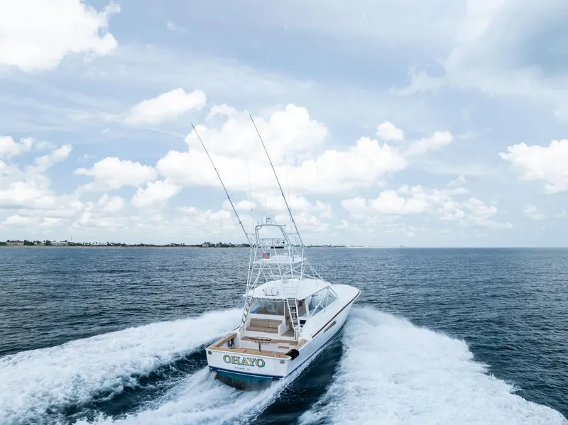 Slide: The Image of 2010 Viking 52 Open yacht cruising on open sea under cloudy sky. - 4