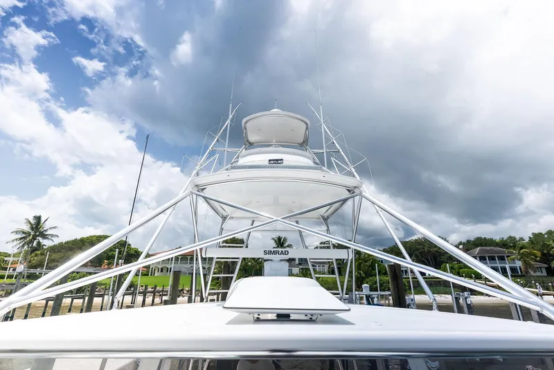 Slide: The Image of 2010 Viking 52 Open yacht docked under cloudy sky, showcasing sleek design and structure. - 40