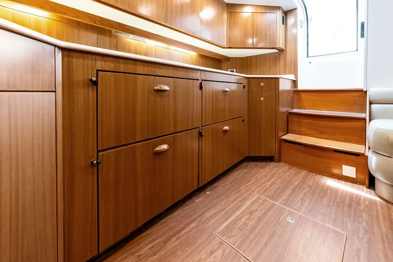 Slide: The Image of Interior of 2010 Viking 52 Open yacht with wooden cabinetry and steps. - 49