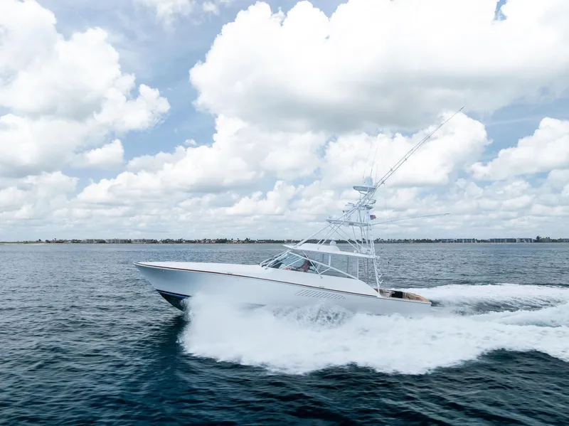 Slide: The Image of 2010 Viking 52 Open yacht cruising on open water under a cloudy sky. - 5