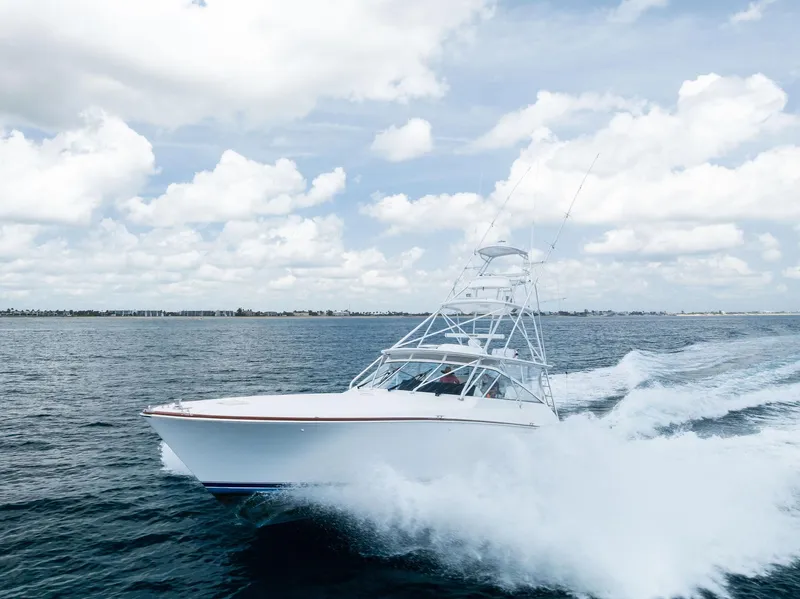 Slide: The Image of 2010 Viking 52 Open yacht cruising on open water under a cloudy sky. - 8