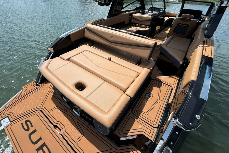 Slide: The Image of 2026 Cobalt R8 Surf boat with luxurious tan interior on the water. - 11
