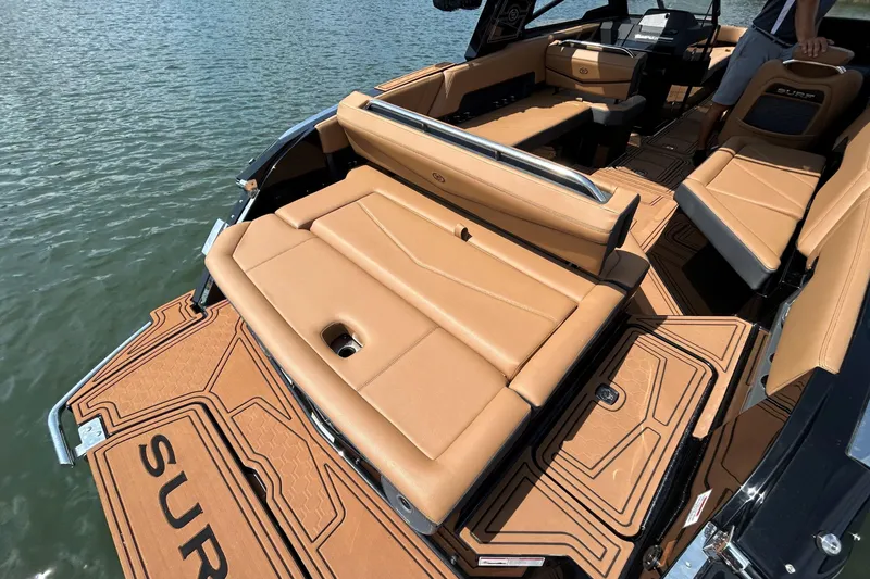 Slide: The Image of 2026 Cobalt R8 Surf boat with luxurious tan seating and sleek design on the water. - 12