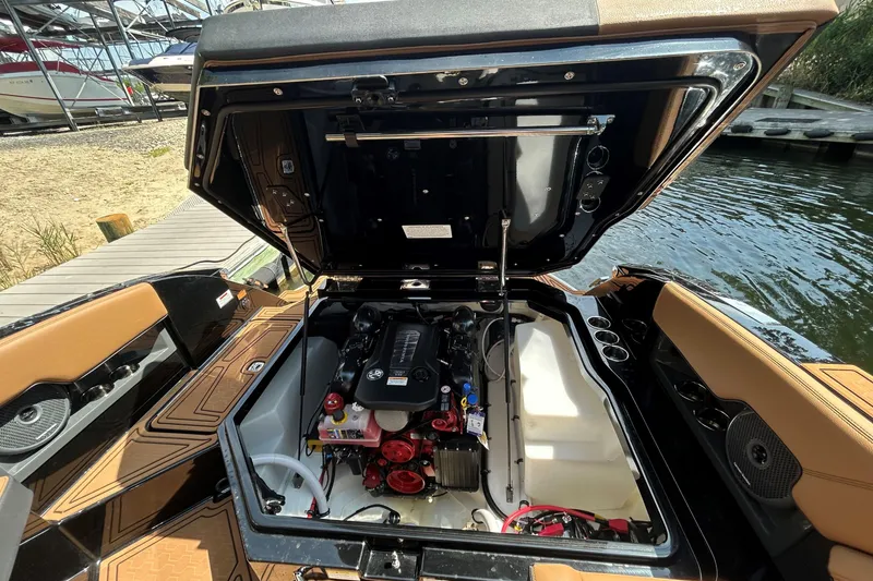 Slide: The Image of 2026 Cobalt R8 Surf boat engine compartment open, dockside view. - 14