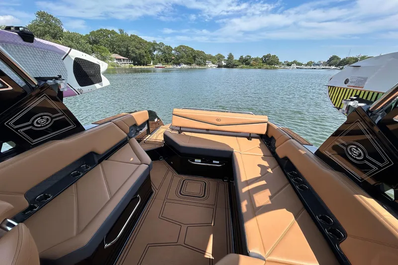 Slide: The Image of Luxurious interior of 2026 Cobalt R8 Surf boat with tan seating and scenic water view. - 19