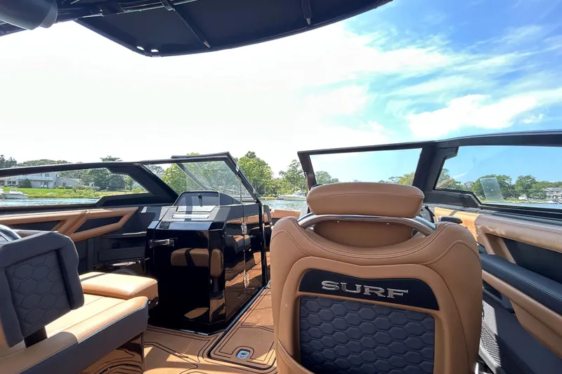 Slide: The Image of Interior of 2026 Cobalt R8 Surf boat with luxurious seating and modern dashboard. - 21