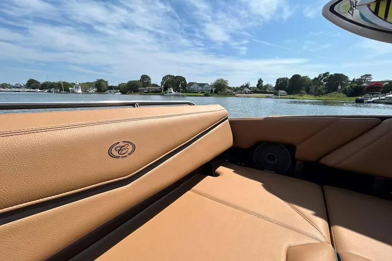 Slide: The Image of 2026 Cobalt R8 Surf boat interior with tan leather seats, scenic waterfront view. - 22