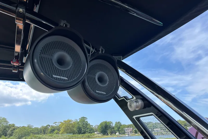 Slide: The Image of Speakers on a 2026 Cobalt R8 Surf boat against a clear sky. - 26