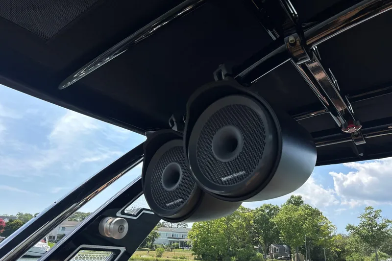Slide: The Image of Speakers on a 2026 Cobalt R8 Surf boat, under a clear blue sky. - 27