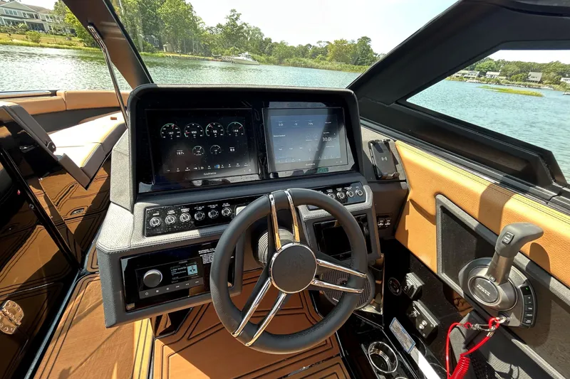 Slide: The Image of 2026 Cobalt R8 Surf boat dashboard with advanced controls and touchscreen display on a sunny day. - 31