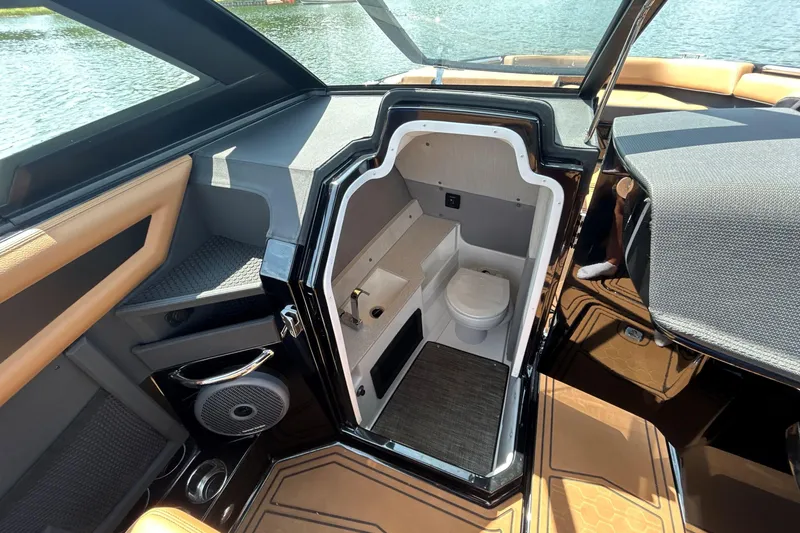 Slide: The Image of 2026 Cobalt R8 Surf boat interior with compact bathroom and modern design. - 36