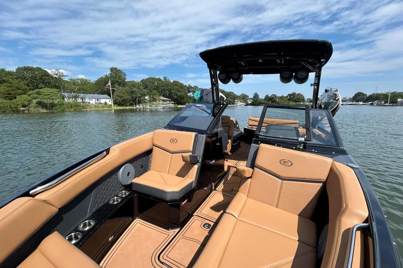 Slide: The Image of 2026 Cobalt R8 Surf boat with tan seating on a calm lake. - 42