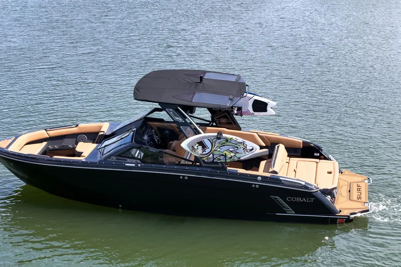 Slide: The Image of 2026 Cobalt R8 Surf boat on water, featuring sleek design and luxurious seating. - 6