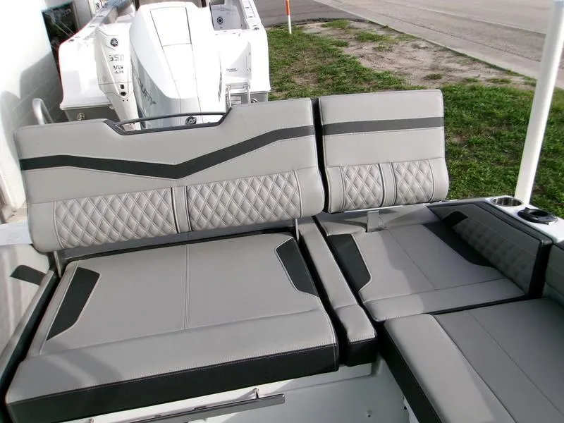 Slide: The Image of 2025 Monterey Elite 27 OB boat interior with gray and black cushioned seating. - 12