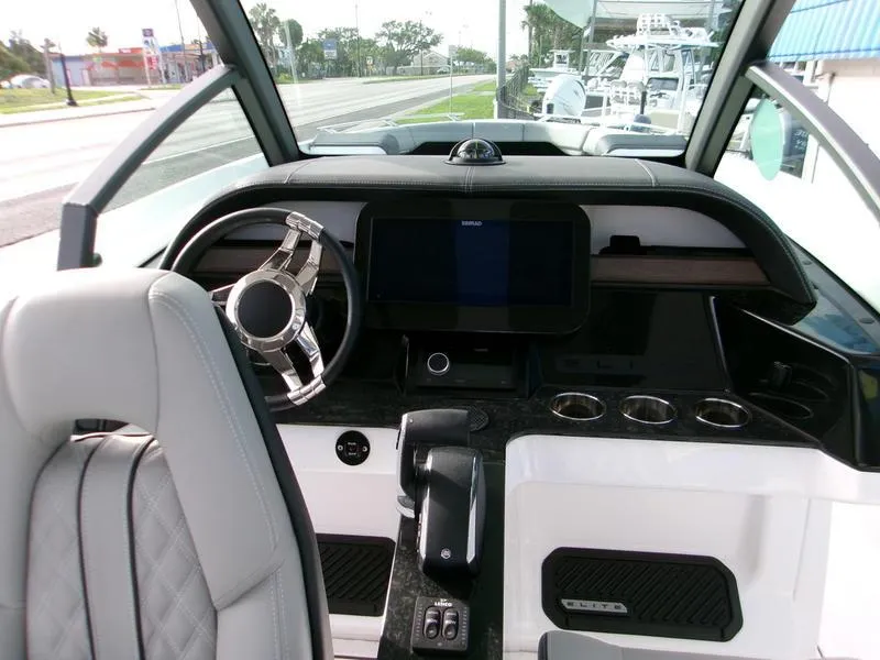 Slide: The Image of 2025 Monterey Elite 27 OB boat dashboard with modern steering and control panel. - 13